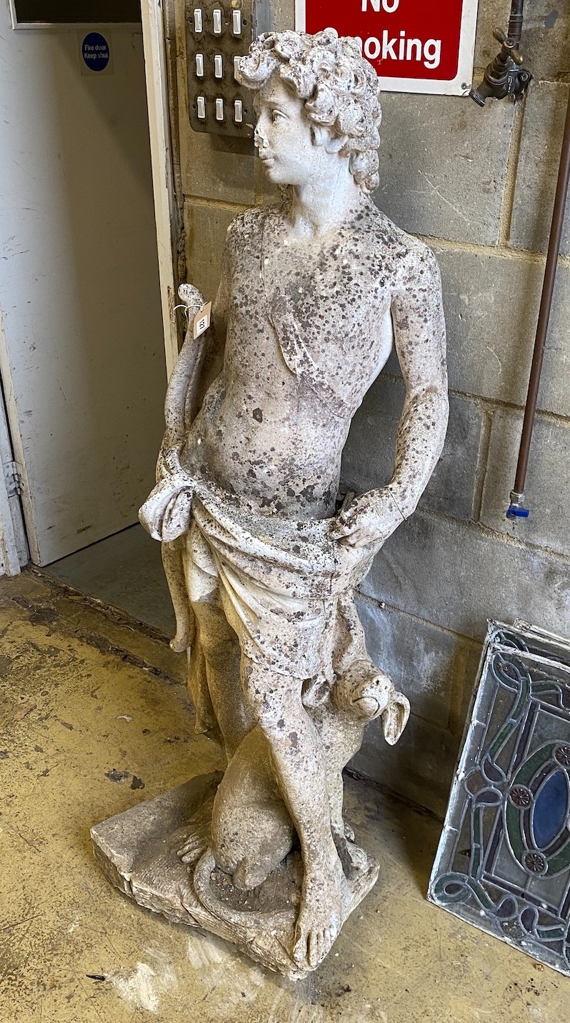 A reconstituted stone garden ornament of a huntsman with hound, height 140cm